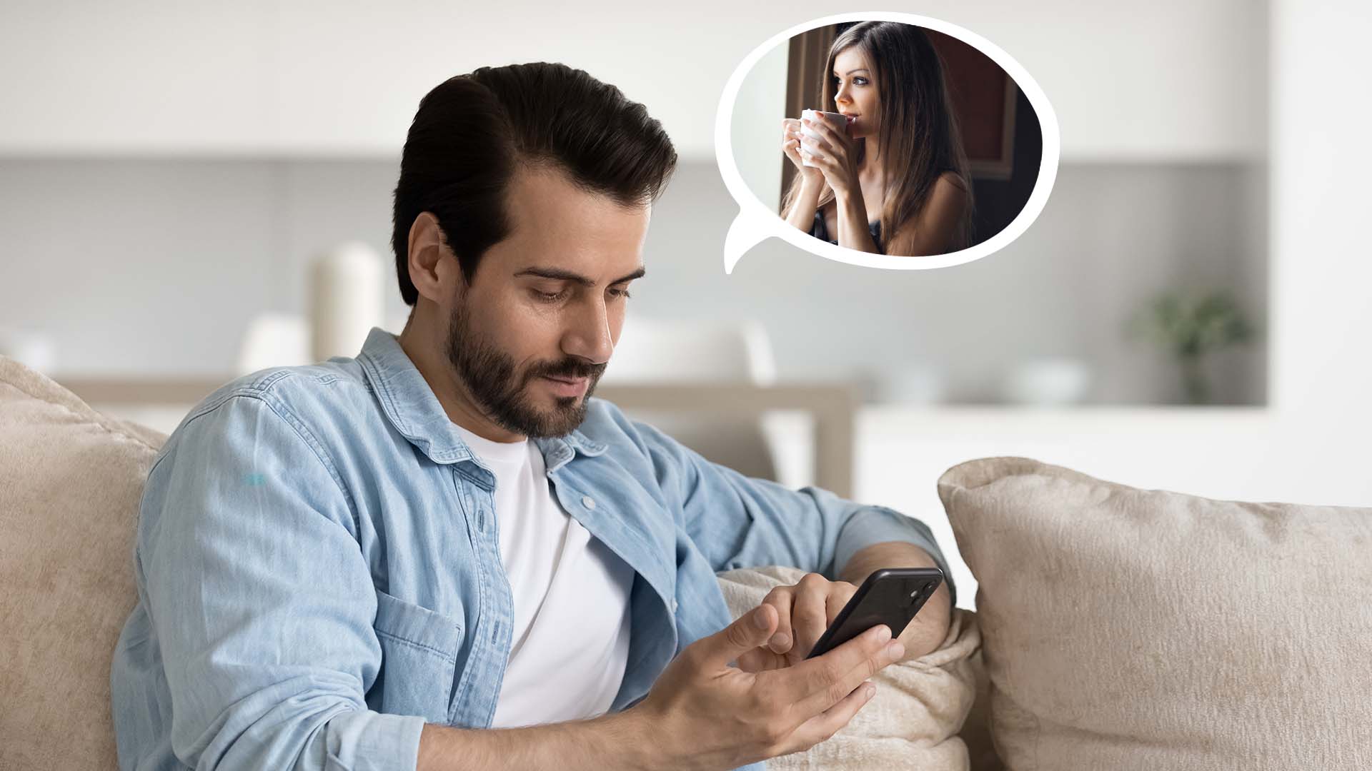 Brunette man in light blue shirt holding his phone and texting on beige couch, thinking about brunette woman drinking coffee.