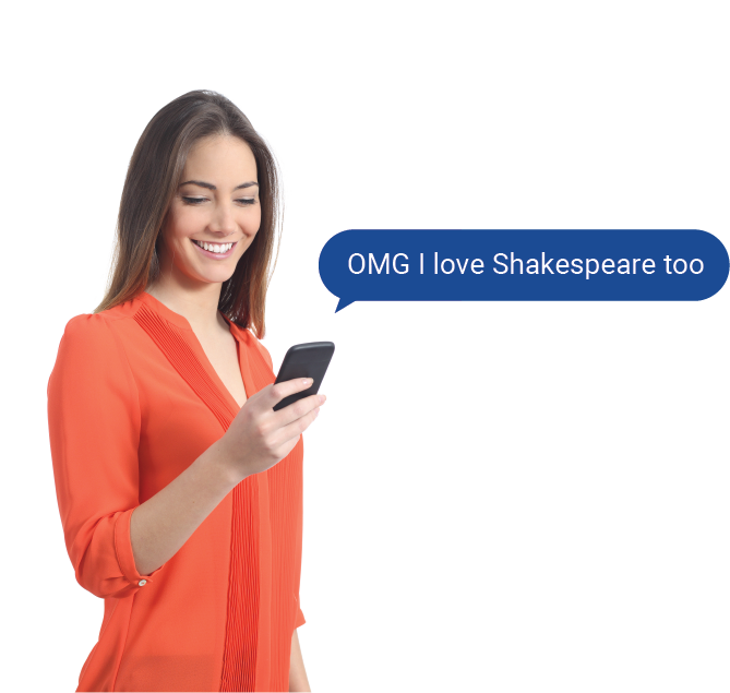 A woman smiling while reading a text 'OMG I love Shakespeare too'.