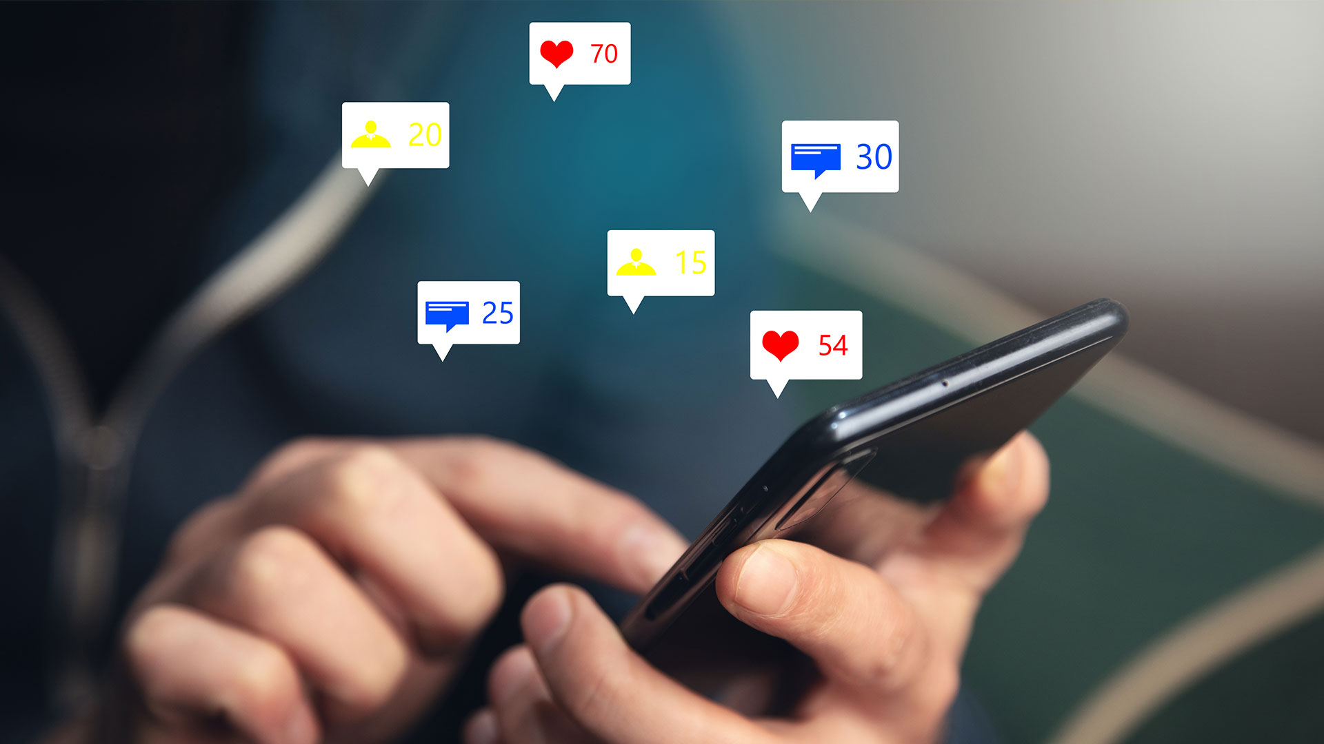 Hands of a man holding a mobile phone with various notifications of messages and likes floating above it.