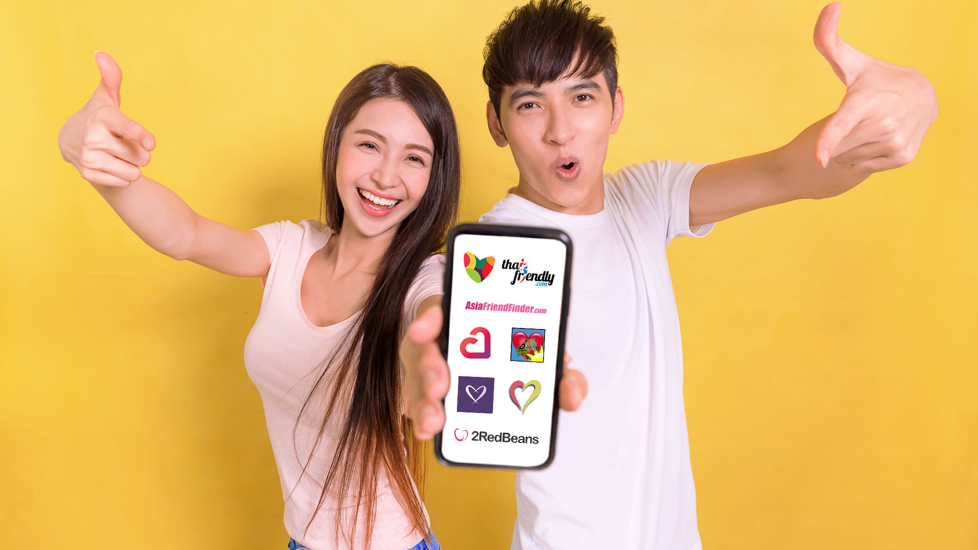Brunette man and woman giving the thumbs up while pointing at the phone they are holding. Yellow background.